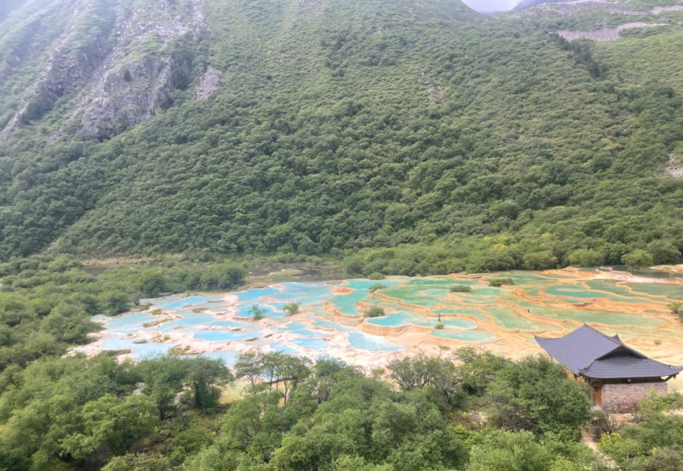Five-Color Pond at Huanglong with layered travertine pools