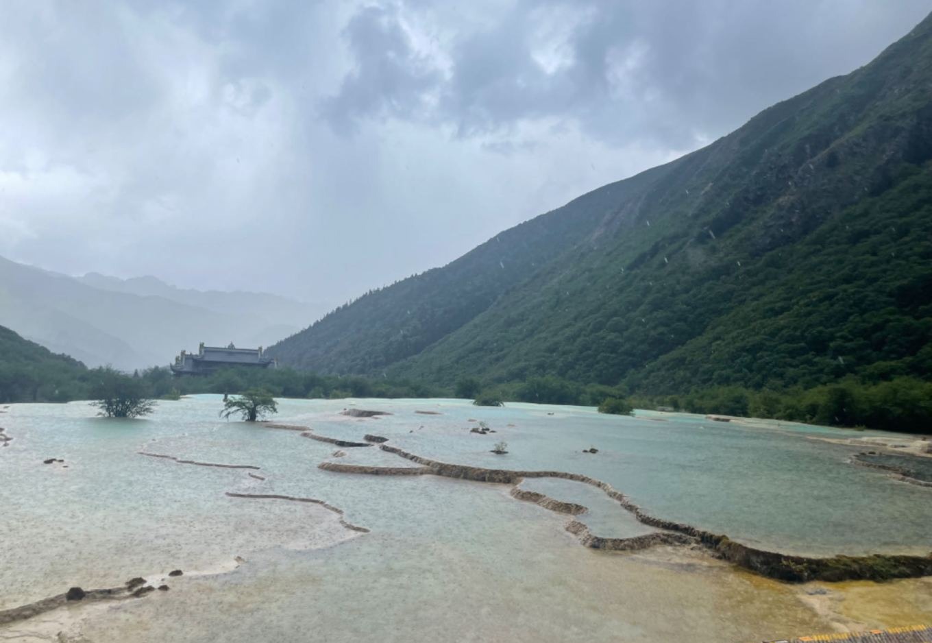 Rain clouds moving away from Huanglong revealing blue sky