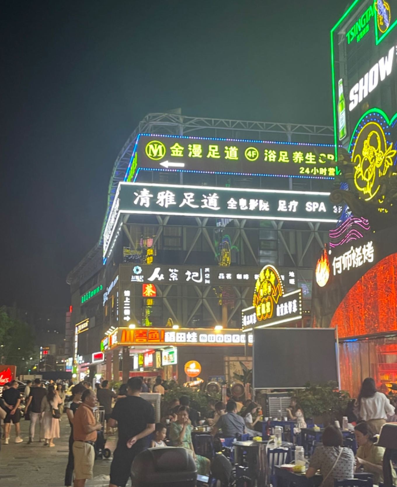 Night market scene near Zhongba area in Chengdu with neon lights and food stalls