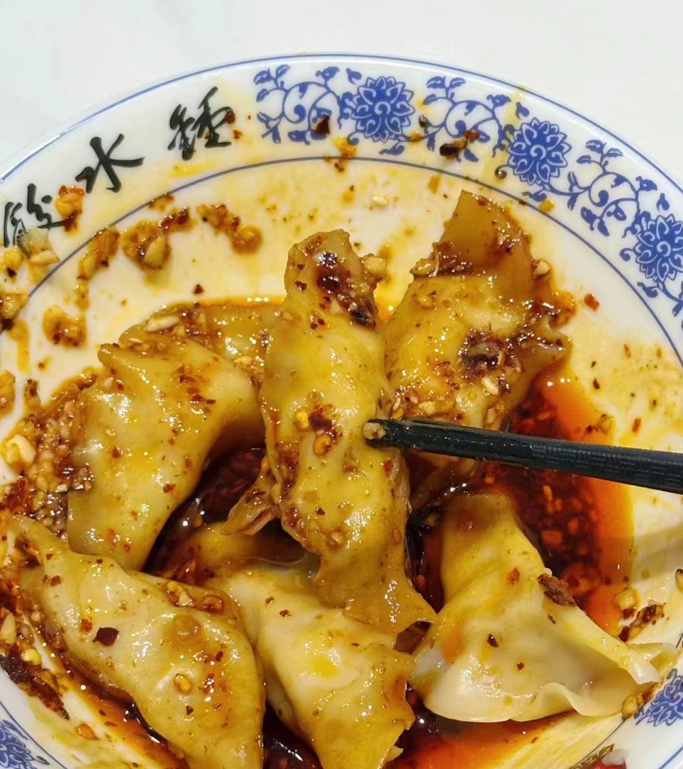 Plate of Zhong Shui Jiao (Zhong dumplings) with red chili oil
