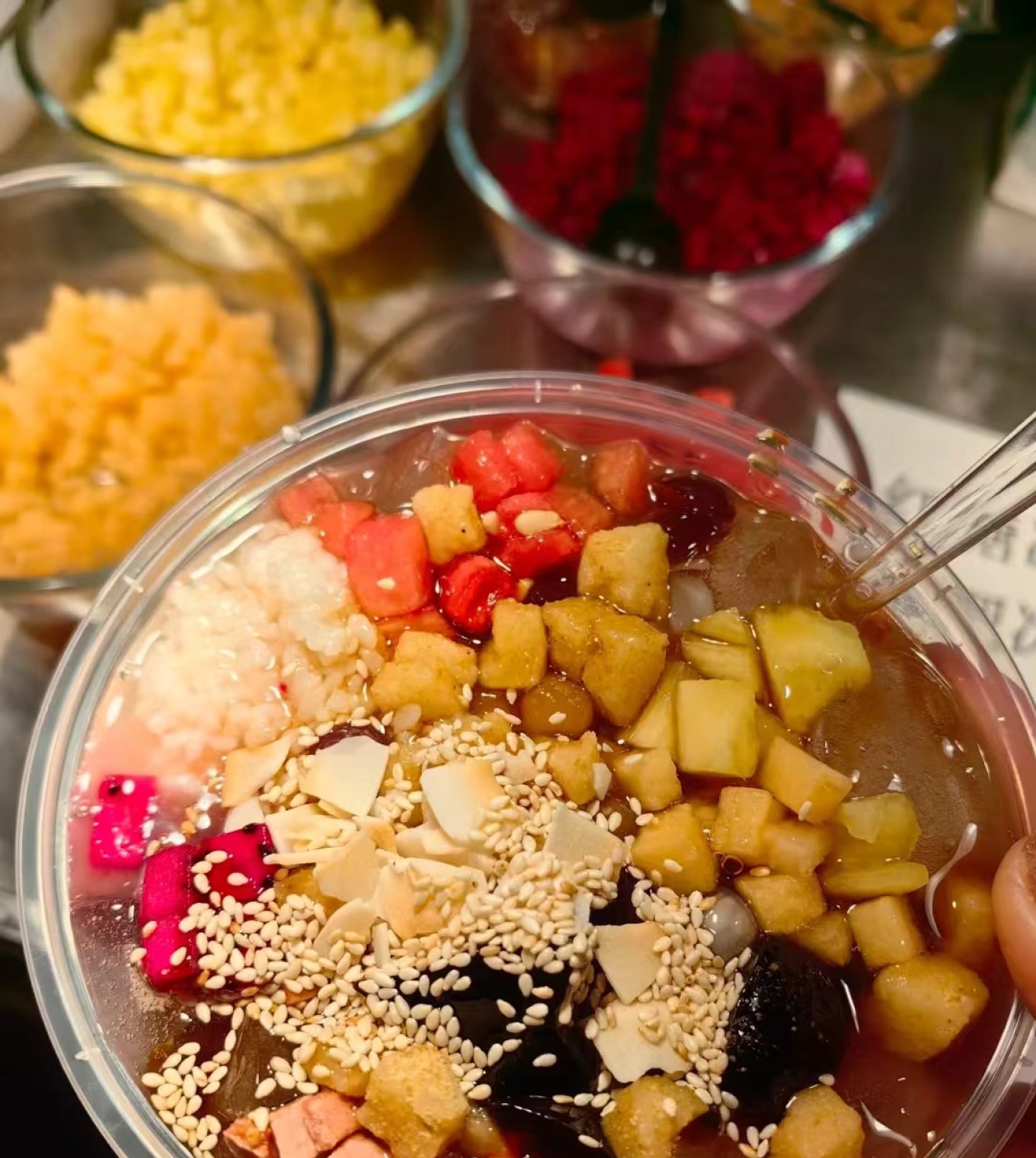 Bowl of Bing Fen (ice jelly) with fruit and brown sugar