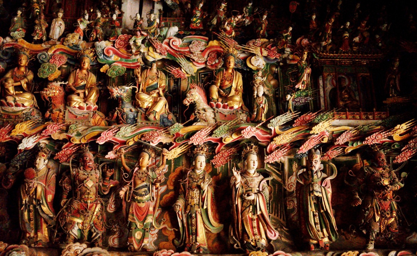 South wall hanging sculptures showing layers of Buddhist and Taoist figures