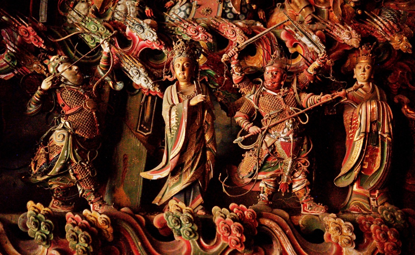 Close-up of Hou Yi and Guan Yu statues among Devas