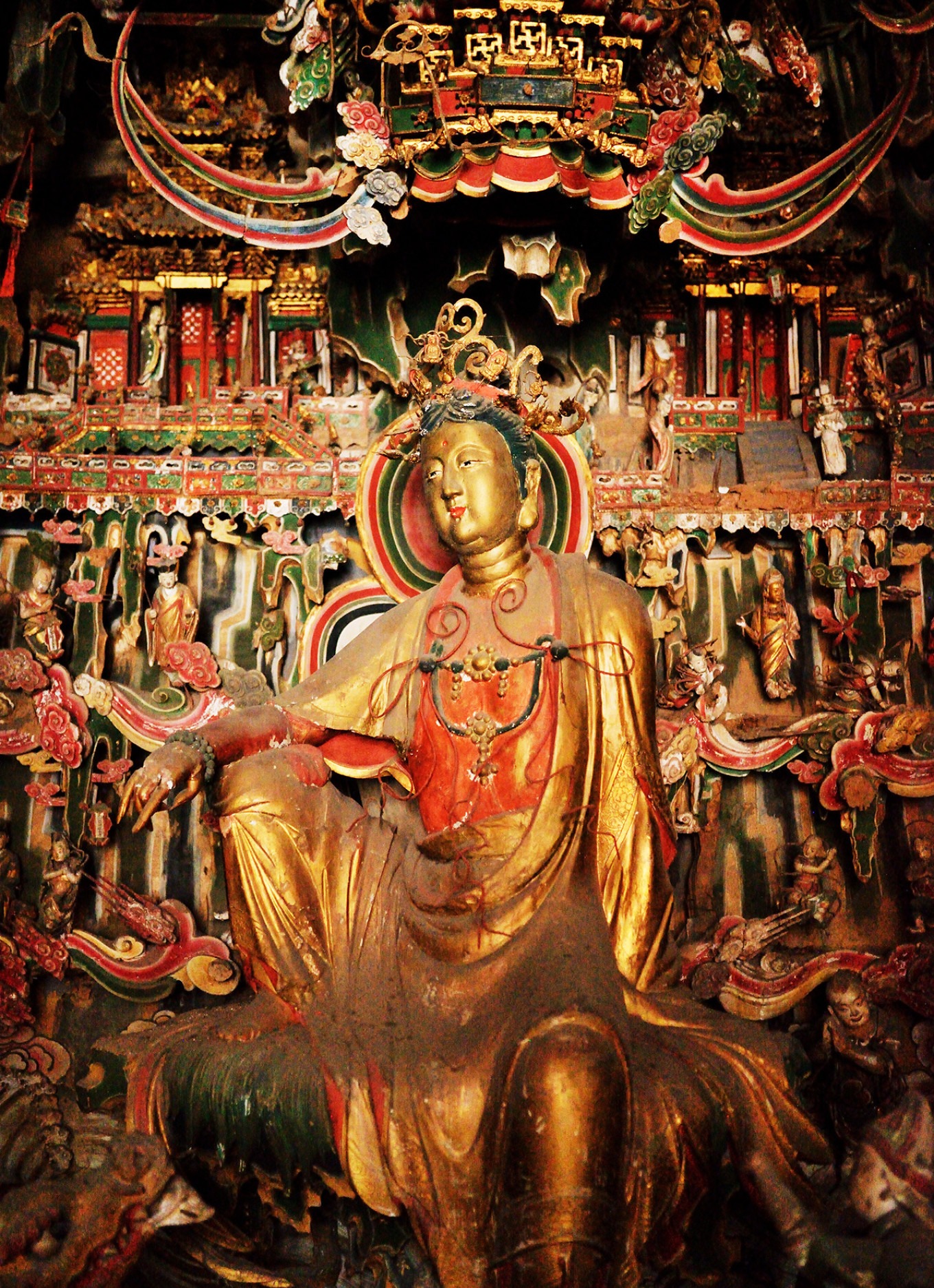 Gilded statue of Guanyin Bodhisattva in relaxed pose