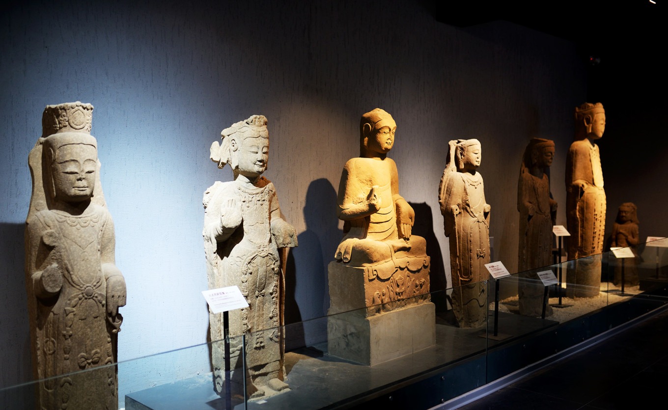 Various small and medium-sized stone carvings on shelves