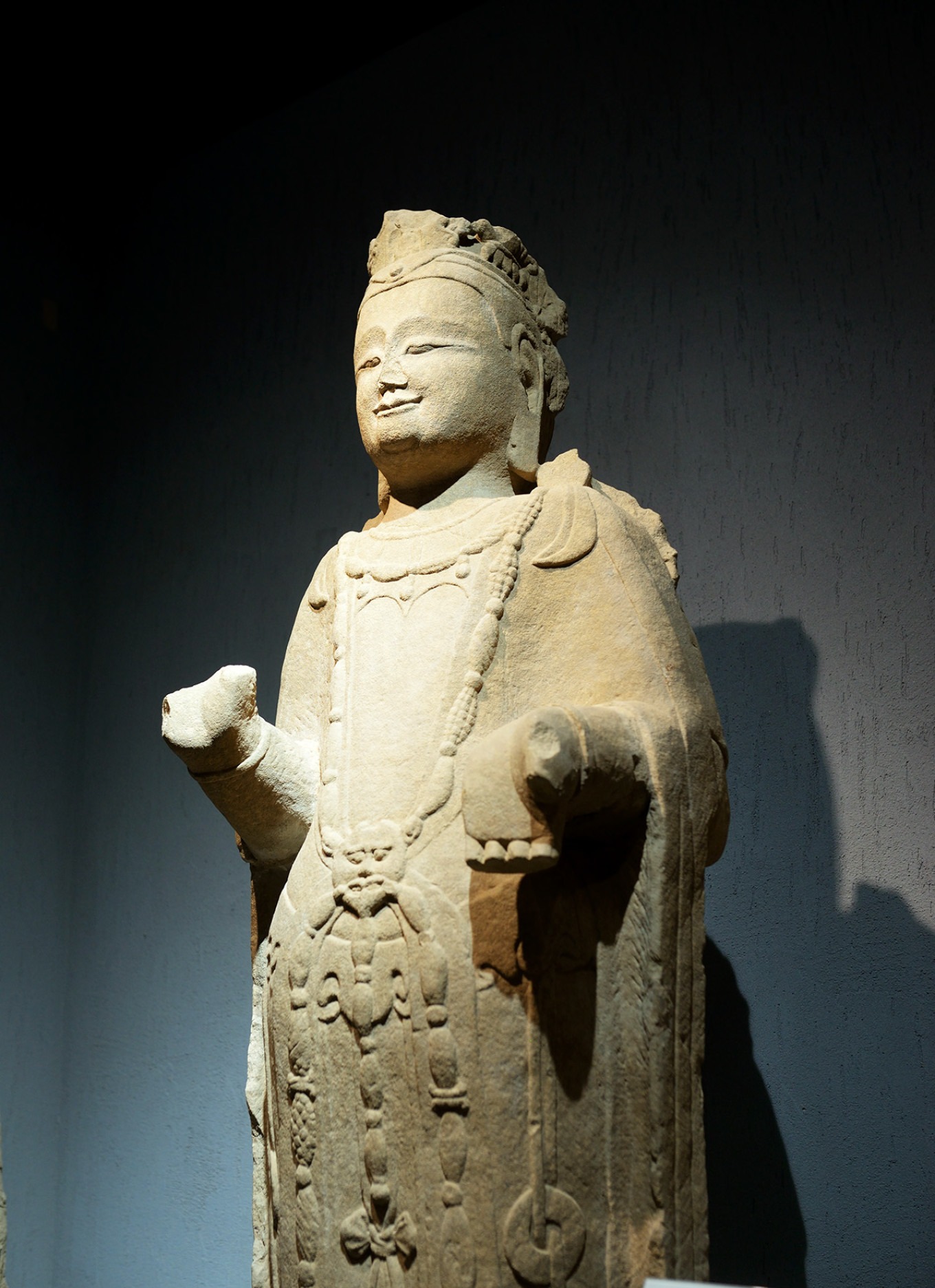 A group of three Buddha statues in different poses