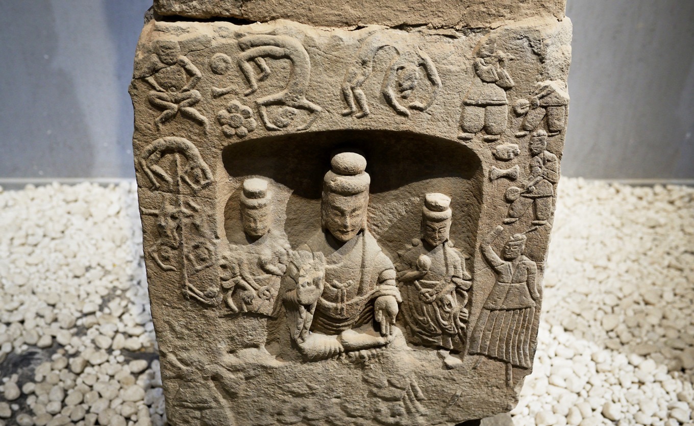 Niche carving showing acrobats, pole climbers, and musicians