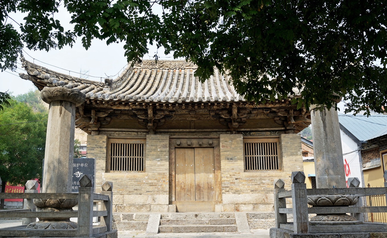 Chunhua Temple exterior view showing the main hall and stone pillars