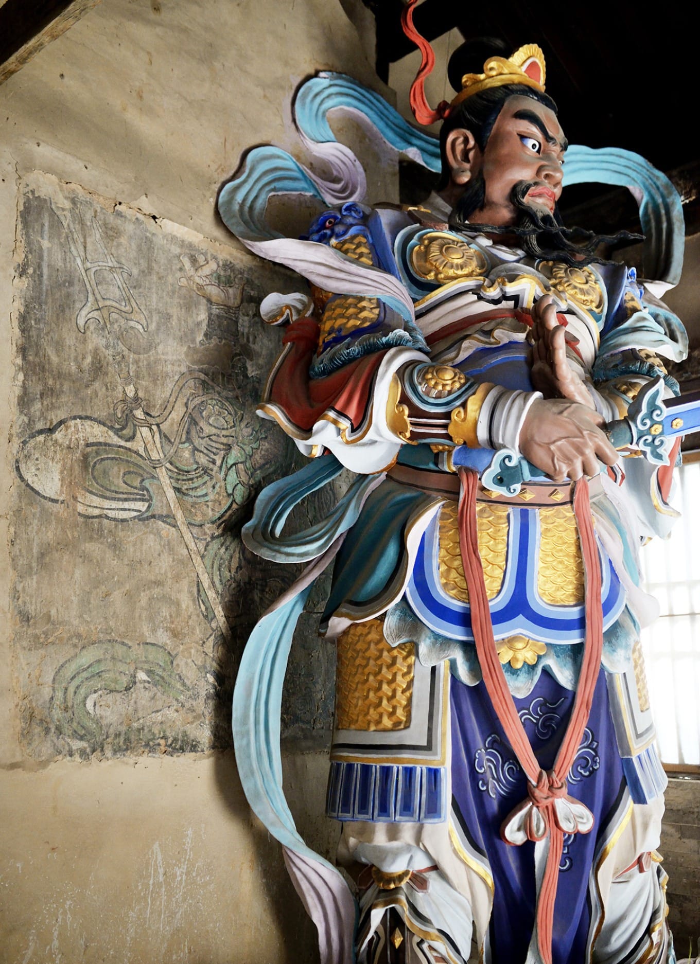 Fragmented murals inside the Heavenly King Hall