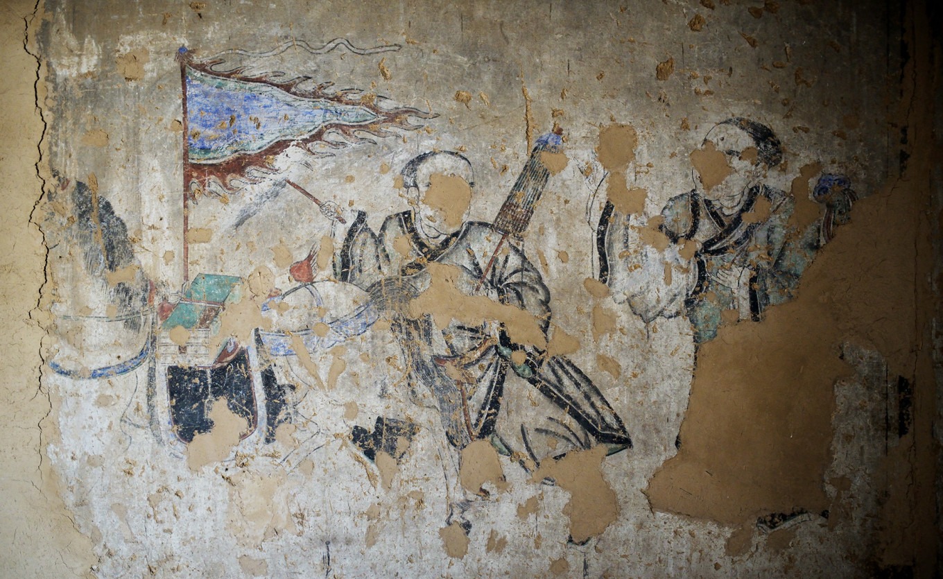 Detail of a mural showing figures and landscape