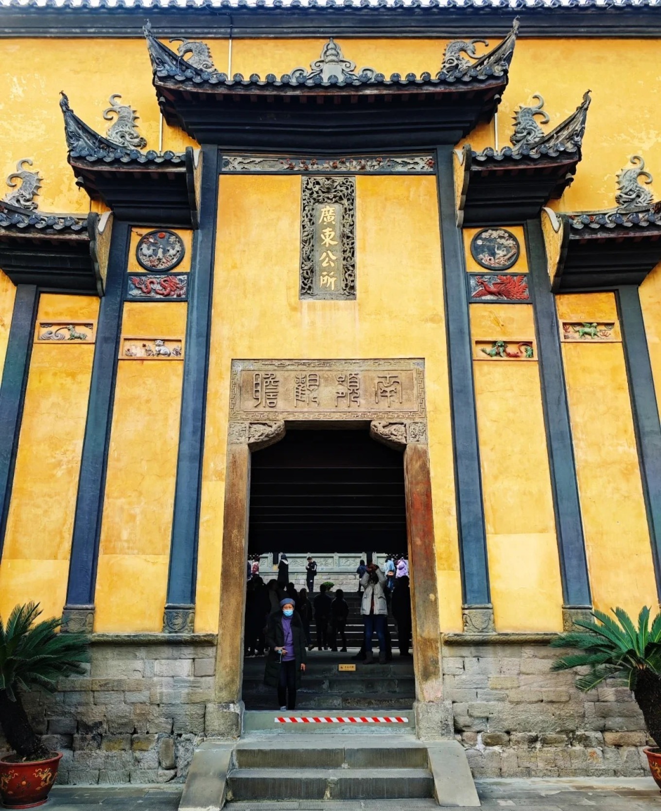 Intricate woodcarving on the stage of Guangdong Assembly Hall depicting scenes from Fengshen Yanyi