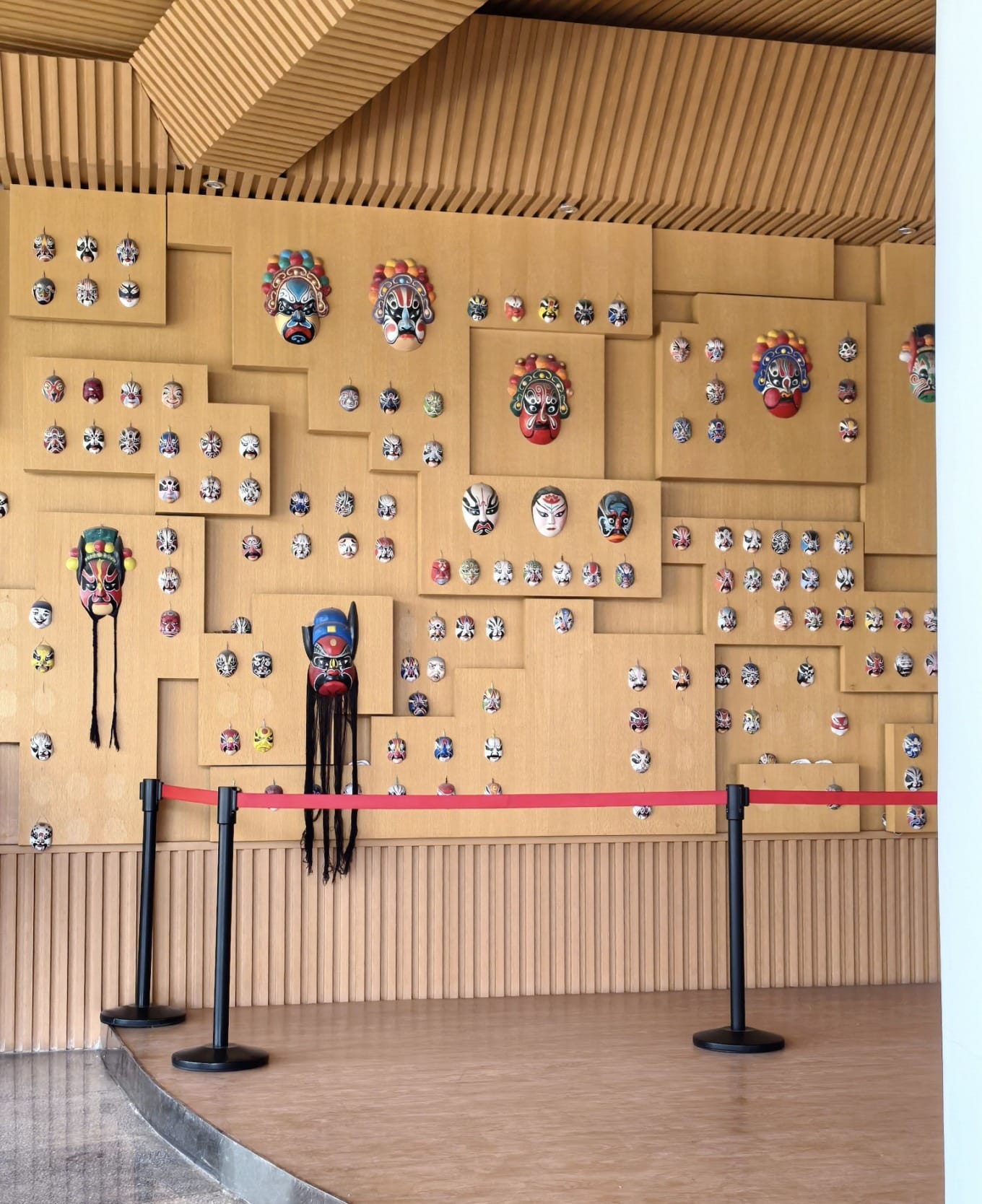 Display of face-painting masks at the entrance of the museum