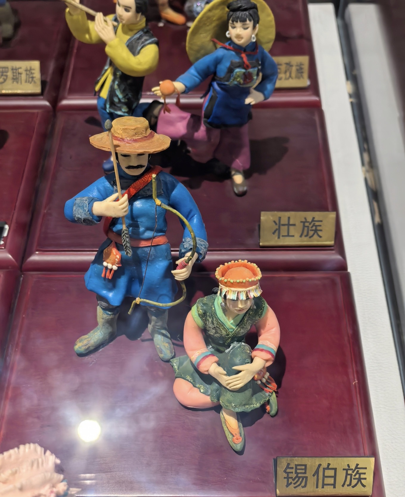 Clay sculpture exhibit showing rural life scenes