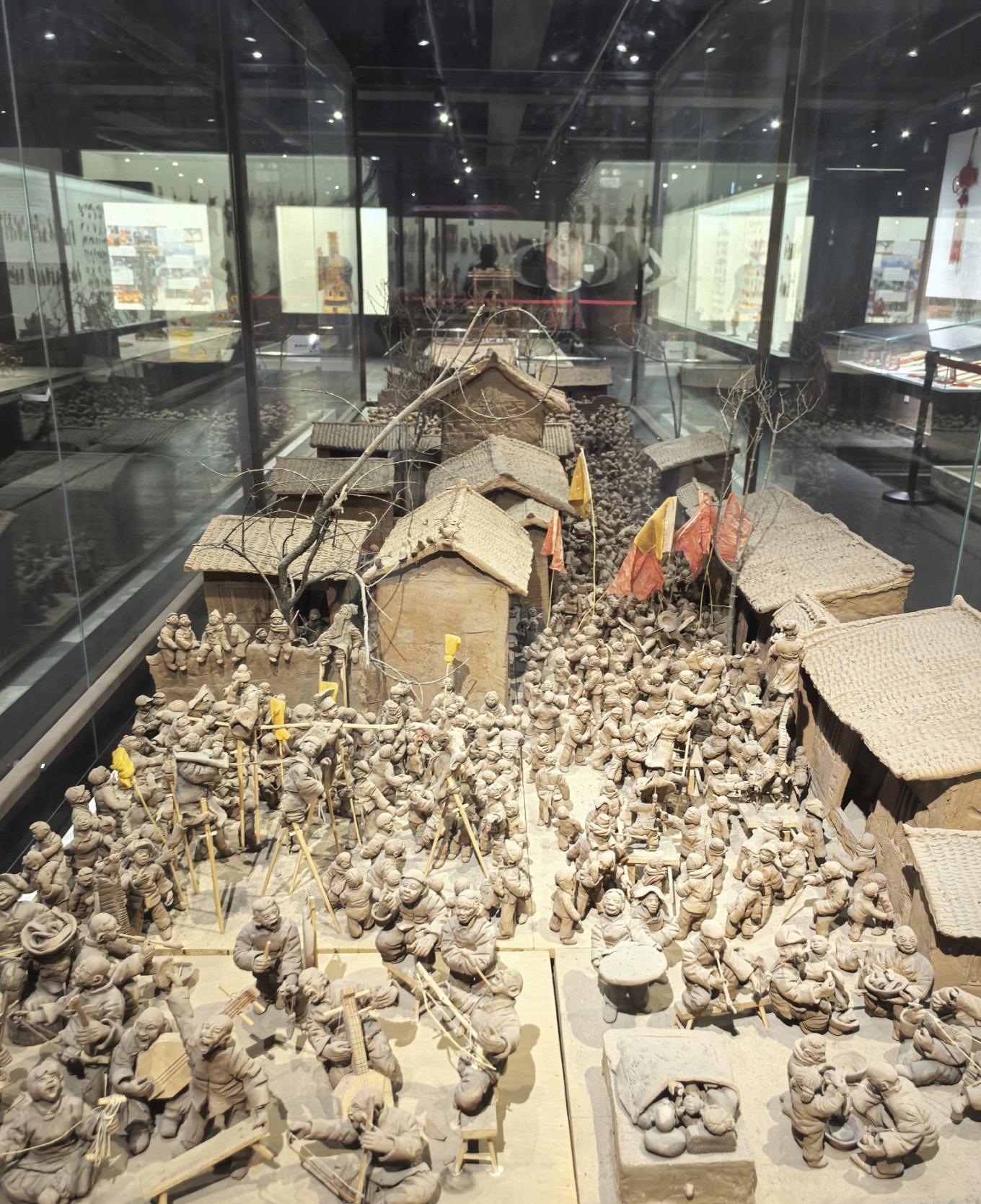 Detailed clay figurines and farm tools exhibit