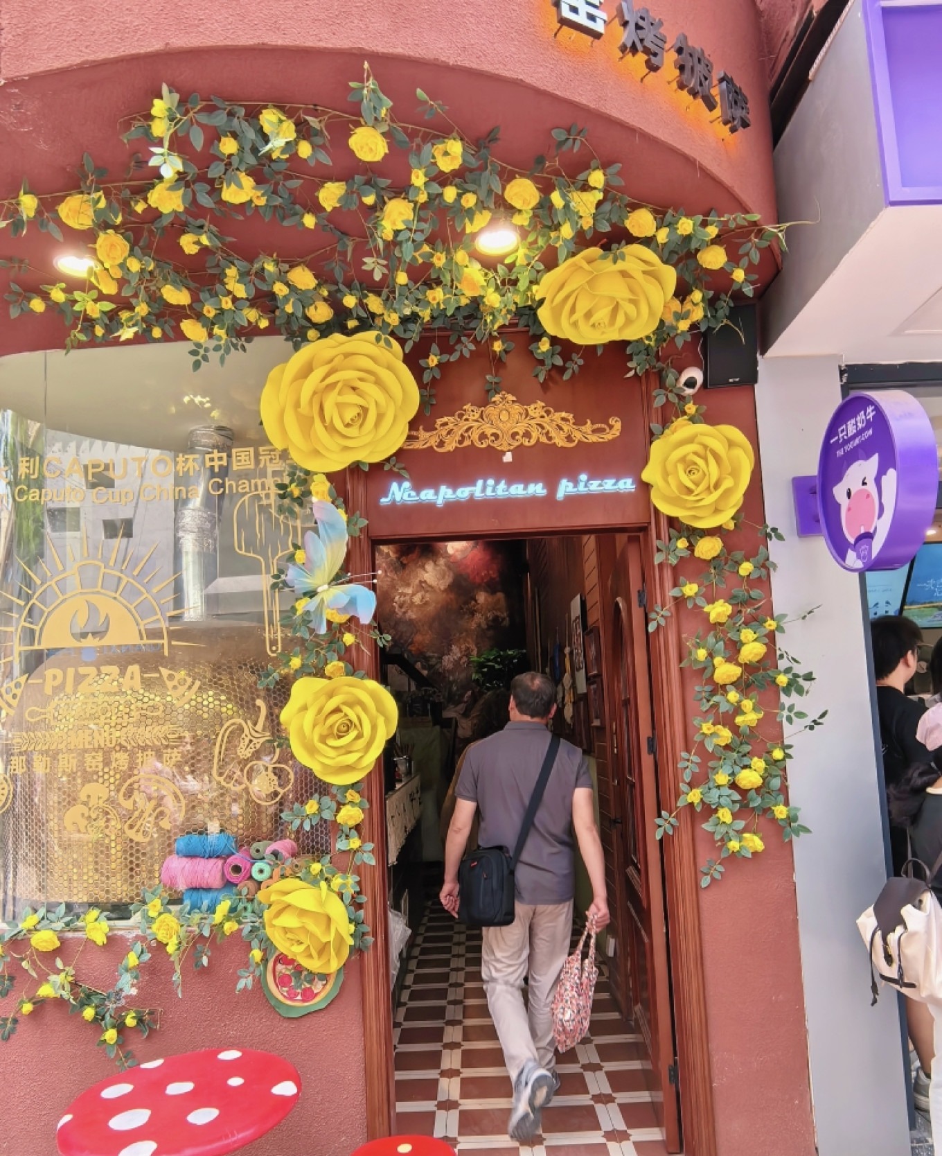 A candid shot of a man walking past a shop in Defu Lane