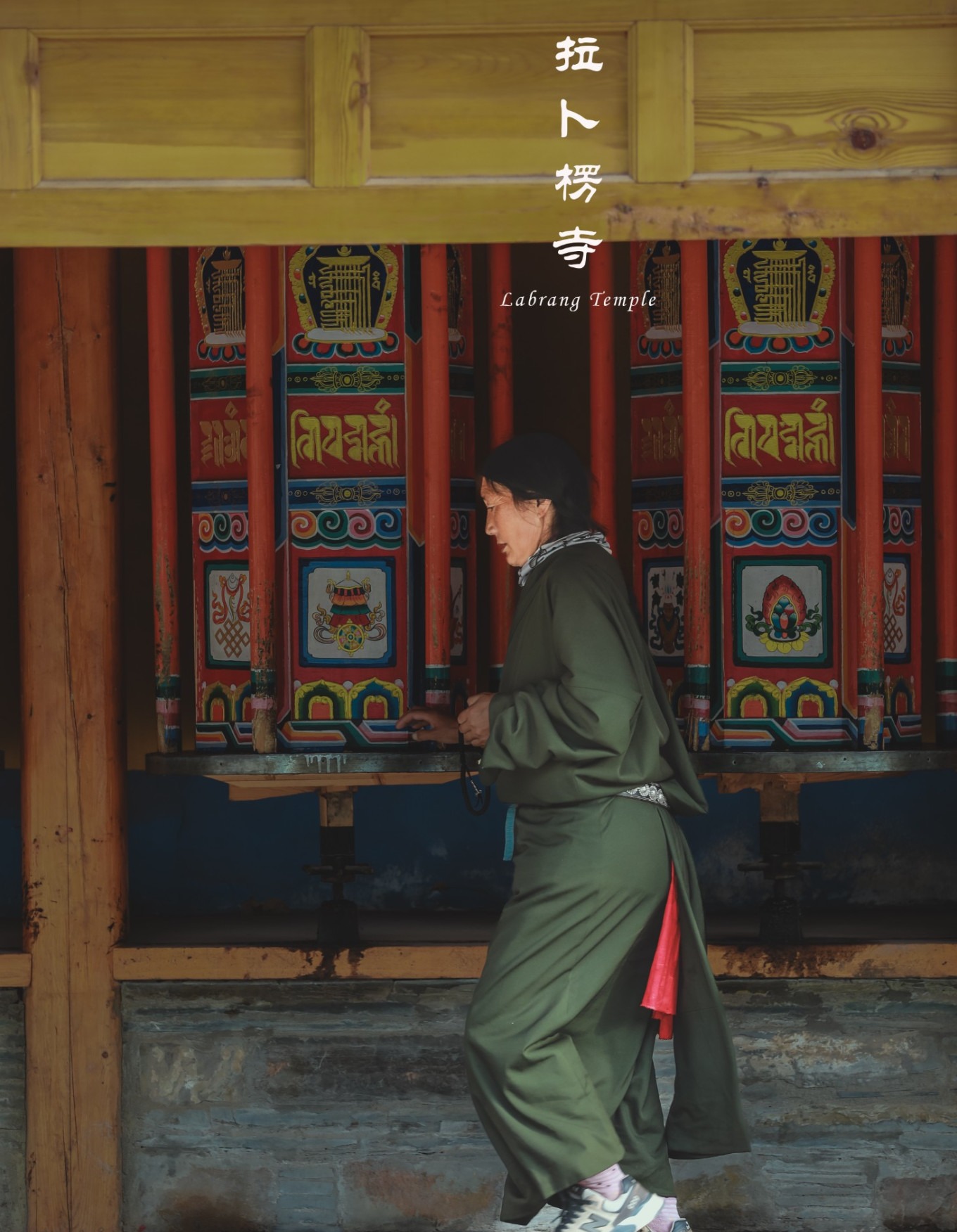 A group of pilgrims turning prayer wheels together