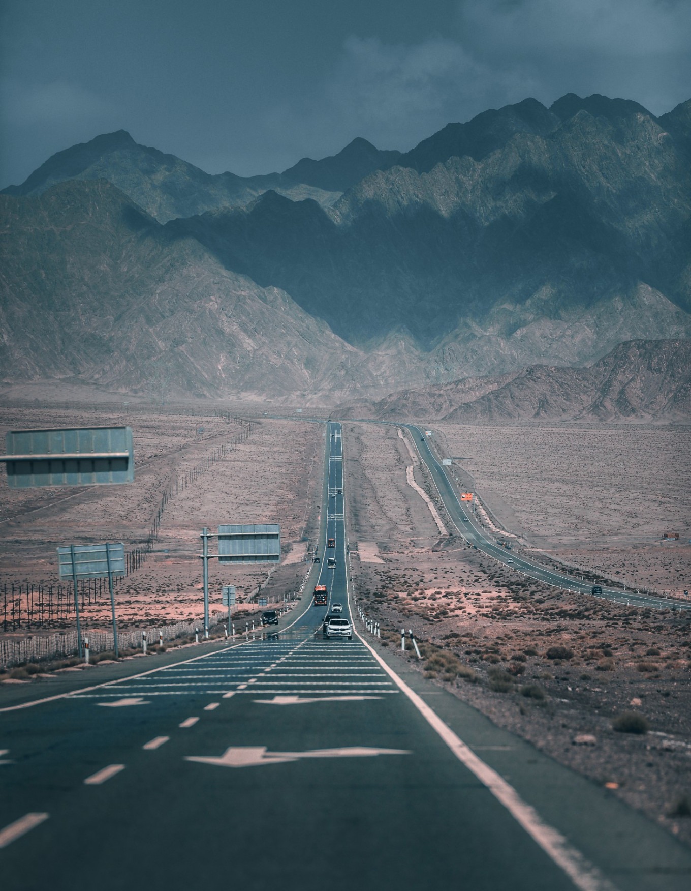 Car parked on desert road with Yadan formations in background