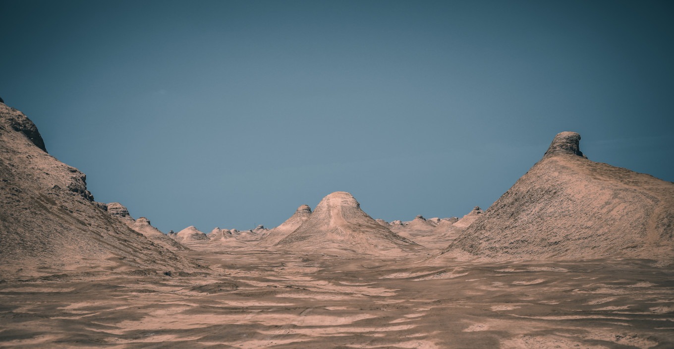 Wide shot of Yadan formations with a person for scale