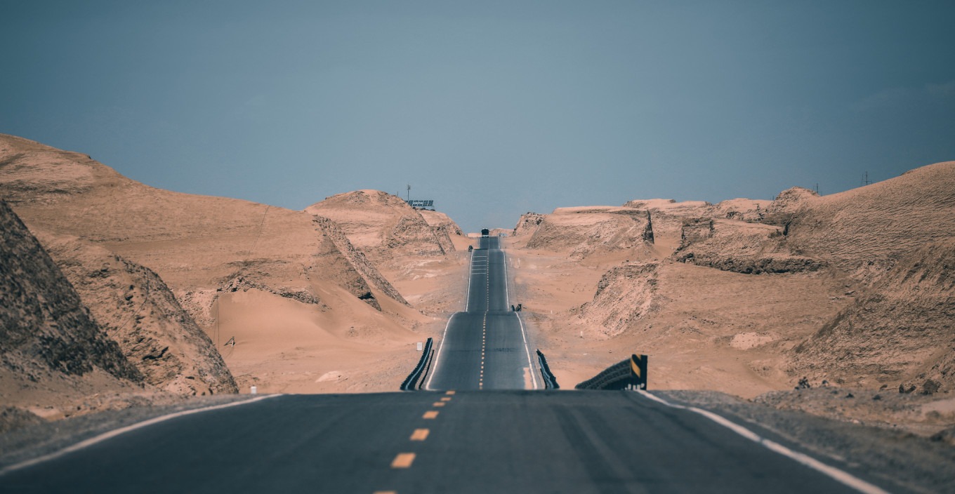 Aerial view of U-shaped road curve in desert