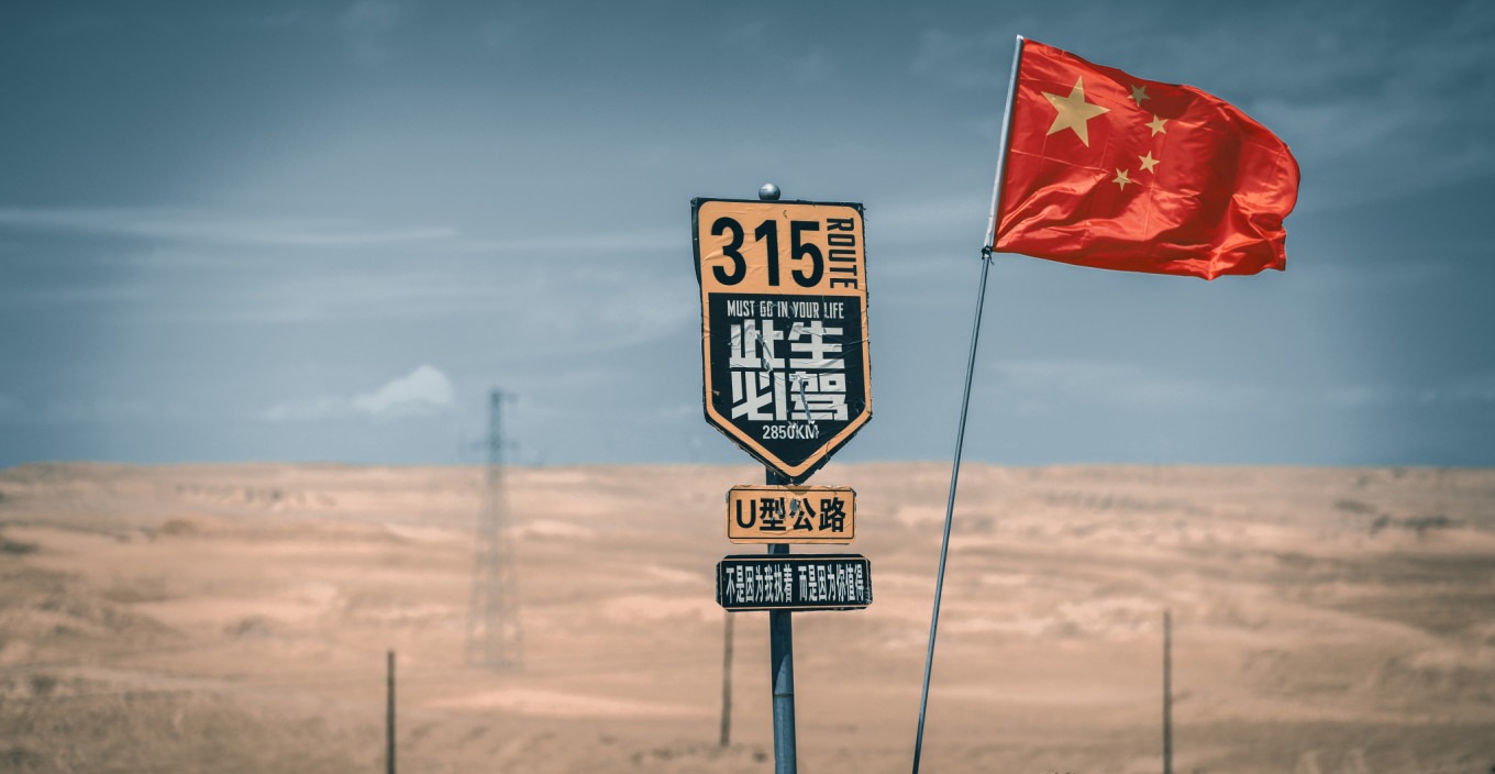 Truck driving on U-shaped road with desert background