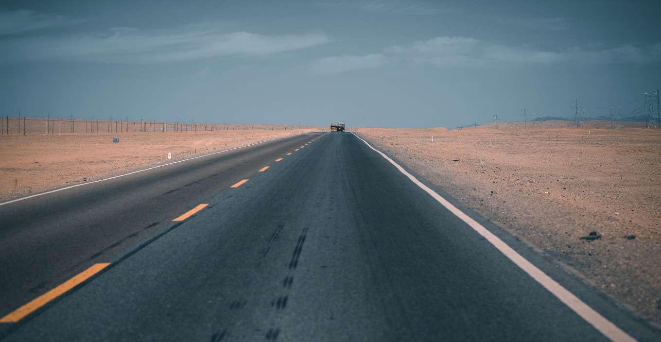 Road sign for G315 with desert landscape