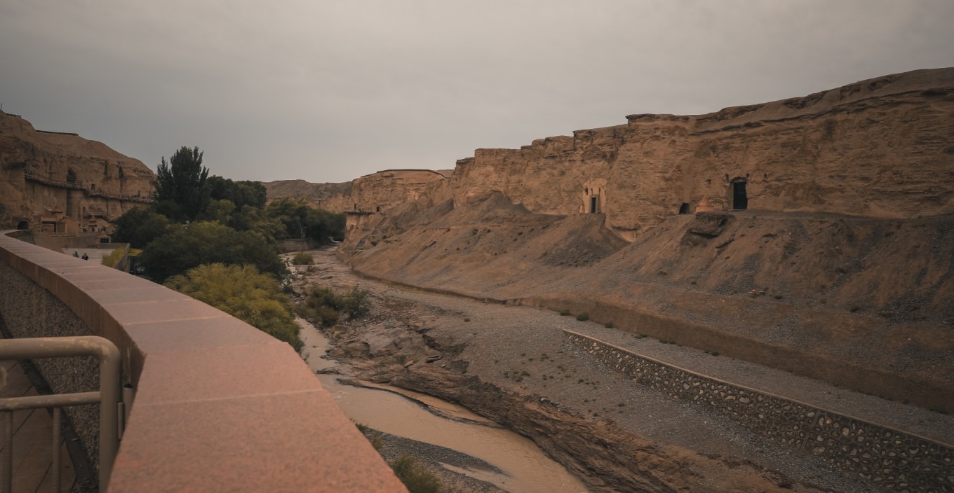 Open caves along the cliff with walkways at Yulin Grottoes