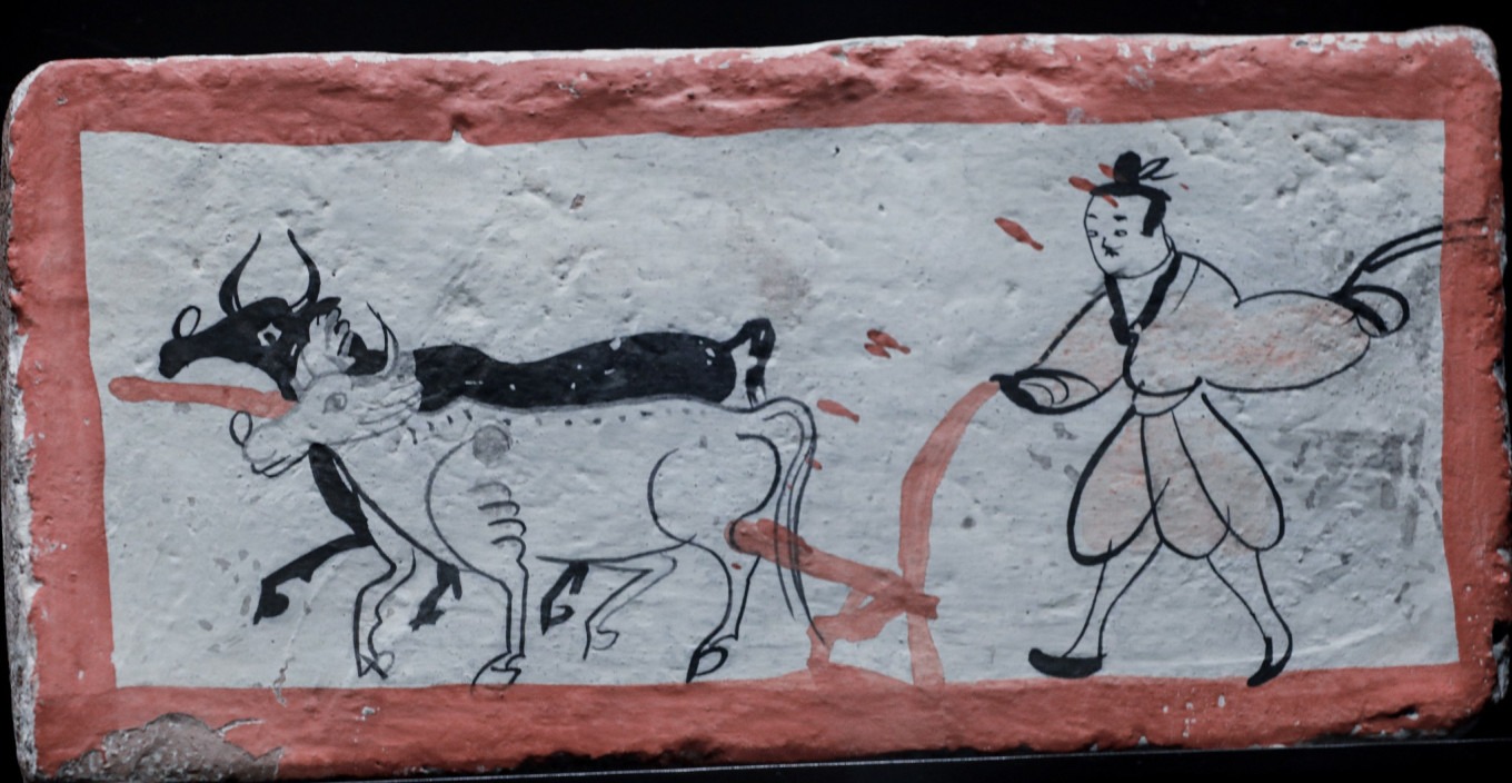 Ox plowing mural brick