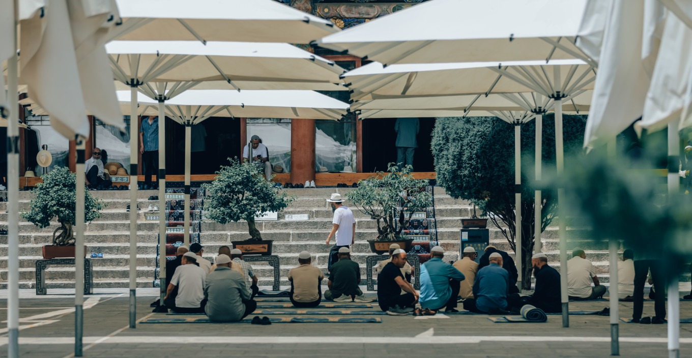 Worshippers gathering in the mosque square before Dhuhr prayer