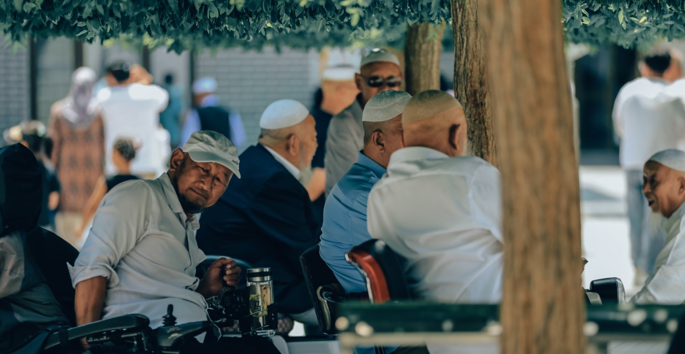 Worshippers waiting in the mosque courtyard