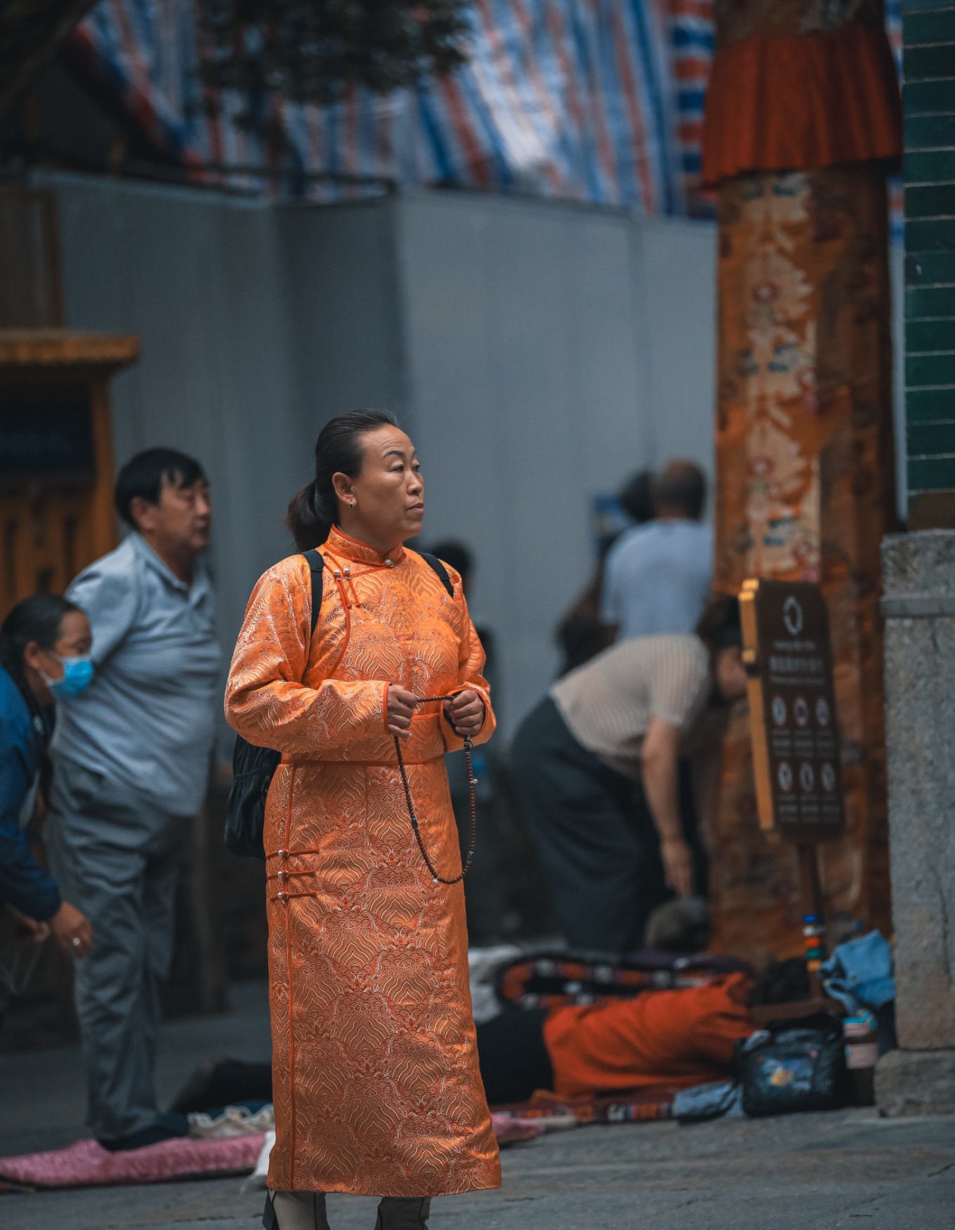 Devotees performing prostrations outside the hall