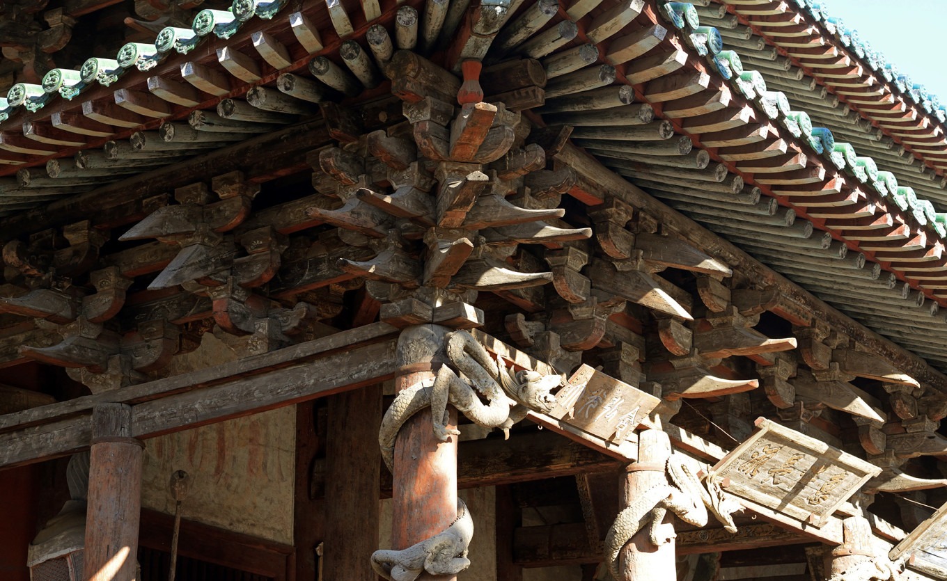 Coiled wooden dragon on front porch column